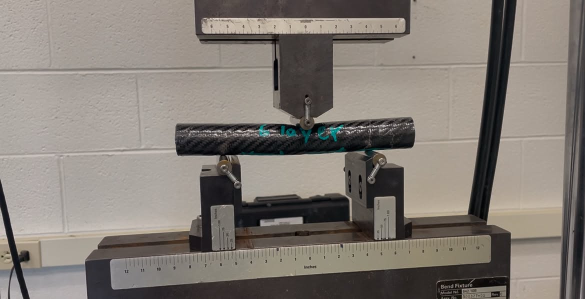 Carbon fiber composite specimen positioned in a mechanical test fixture